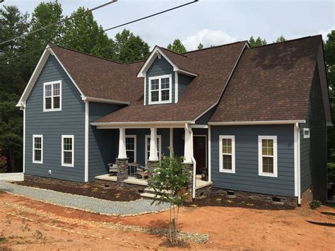 brown metal roof blue house white shutters|brown and blue exterior ideas.